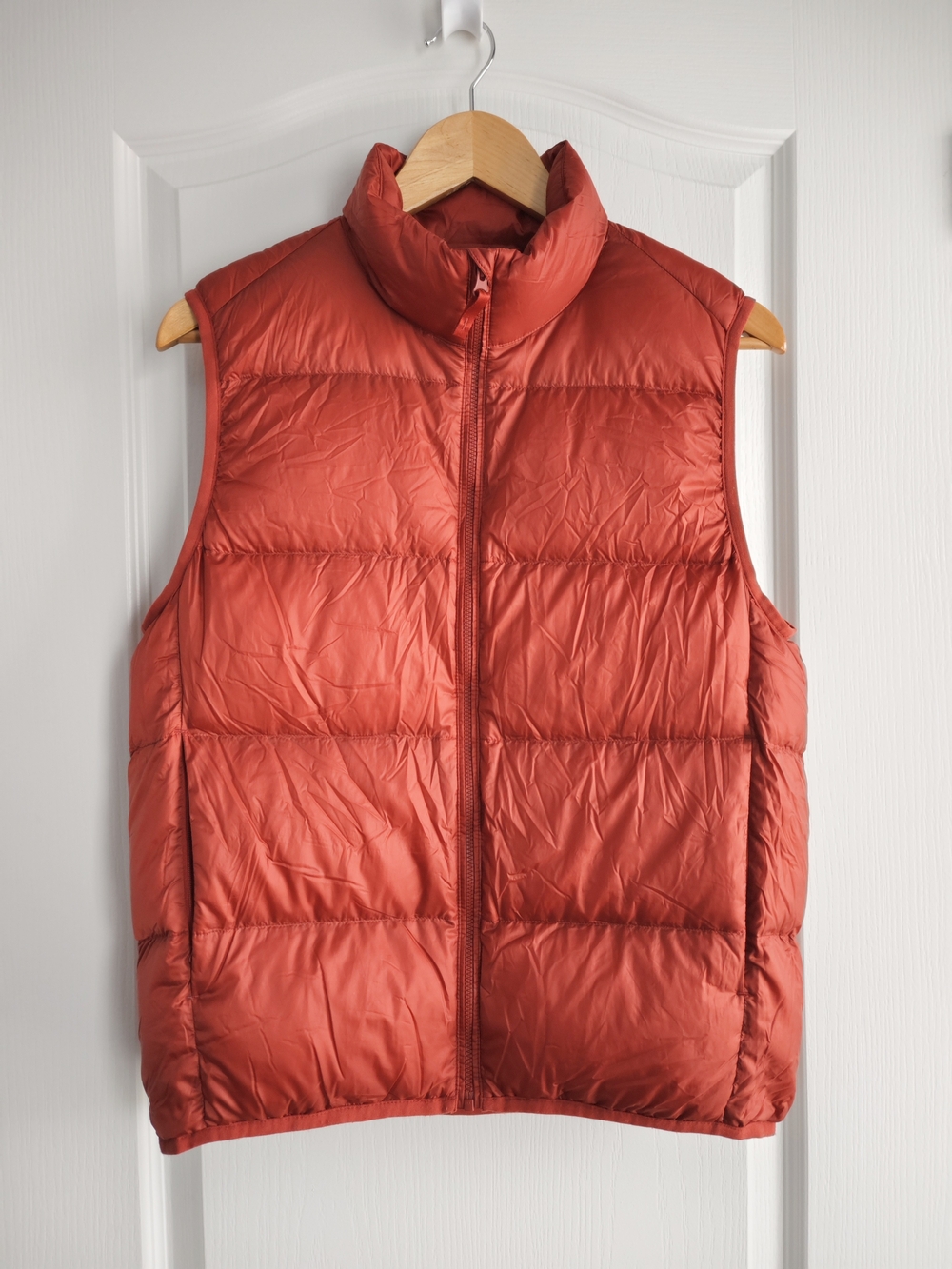 Uniqlo women's ultra light weight down vest, in a portal bag